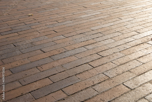 Square pavement paved with gray tiles rectangles texture