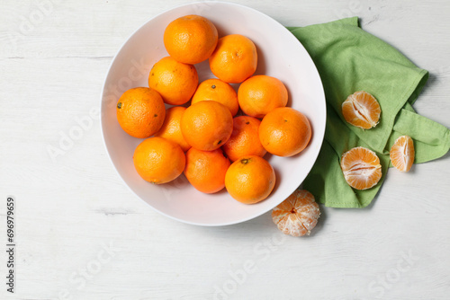 White bowl with fresh tangerines on white background © Jorge Urraca