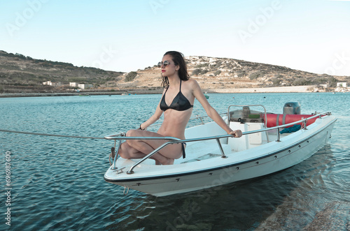 young beautiful woman on a small boat