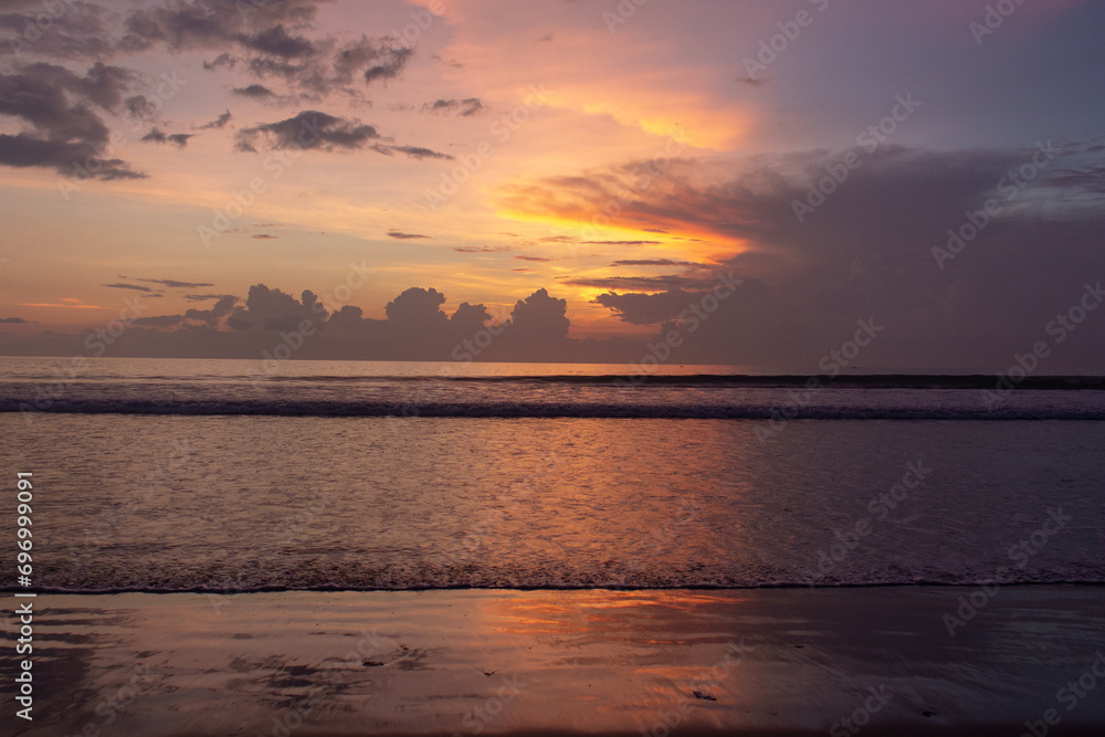 A tranquil beachscape at sunset with soft pastel colors in the sky reflecting on gentle ocean waves. A tranquil beachscape at sunset with soft pastel colors in the sky reflecting on gentle ocean waves.