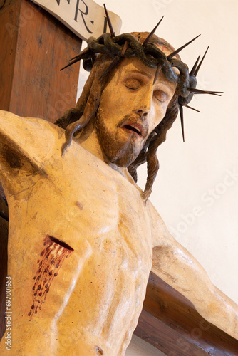 VICENZA, ITALY - NOVEMBER 7, 2023: The detail of medieval carved polychrome statue of Crucifixion in the church Chiesa di Santa Corona by unknown artist of 14. cent. 