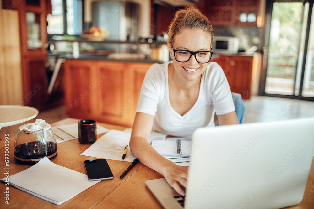 Smiling woman working from home on laptop Smiling woman working from home on laptop