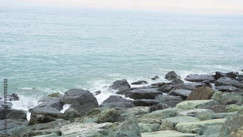Sea waves hit the rocky shore creating splashes. Calmness and tranquility, meditation and relaxation, a screensaver of natural beauty. Rocky shore and waves Sea waves hit the rocky shore creating splashes. Calmness and tranquility, meditation and relaxation, a screensaver of natural beauty. Rocky shore and waves