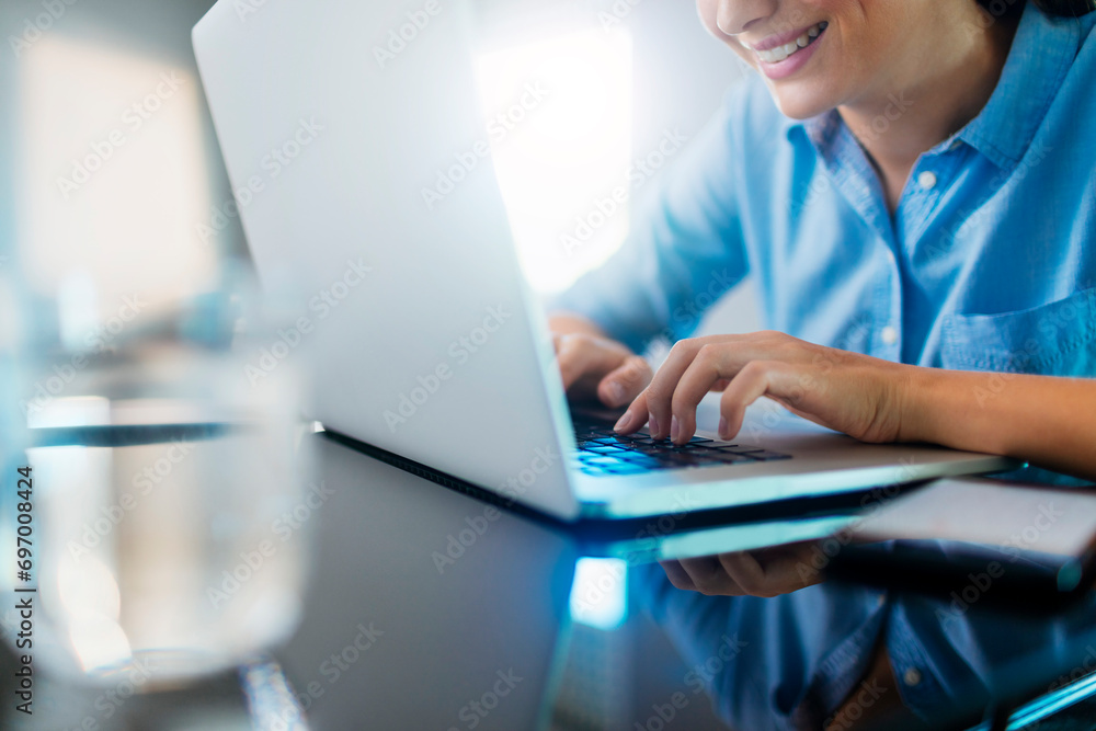 Close up of a woman working on the laptop with smile Close up of a woman working on the laptop with smile