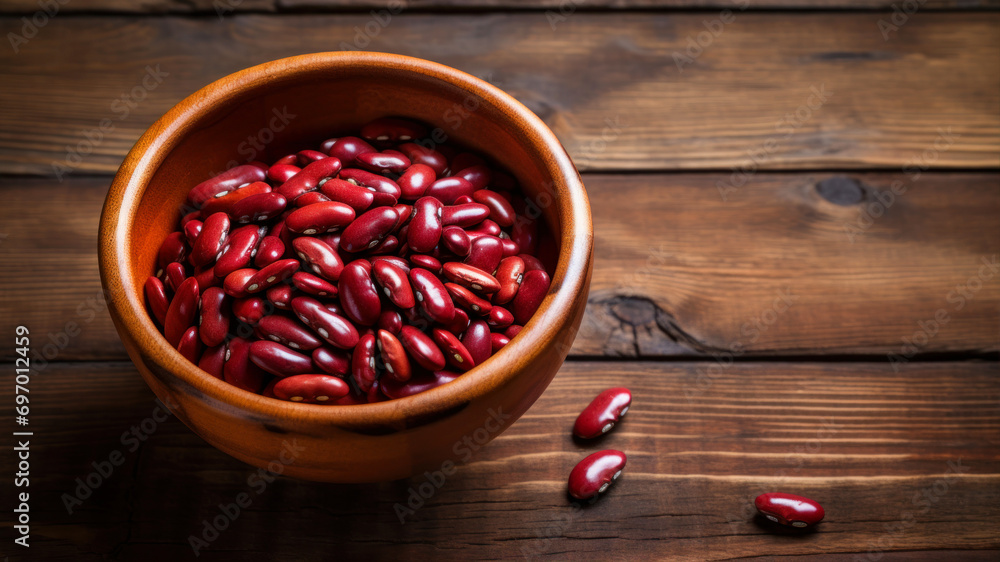 Red kidney beans in a bowl on a wooden background. Selective focus. Red kidney beans in a bowl on a wooden background. Selective focus.
