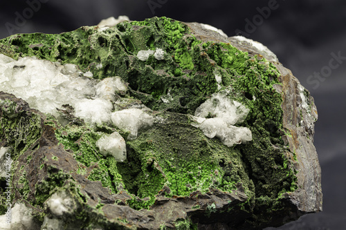 Close-Up of Vibrant Green Epidote Mineral Specimen on Dark Background photo