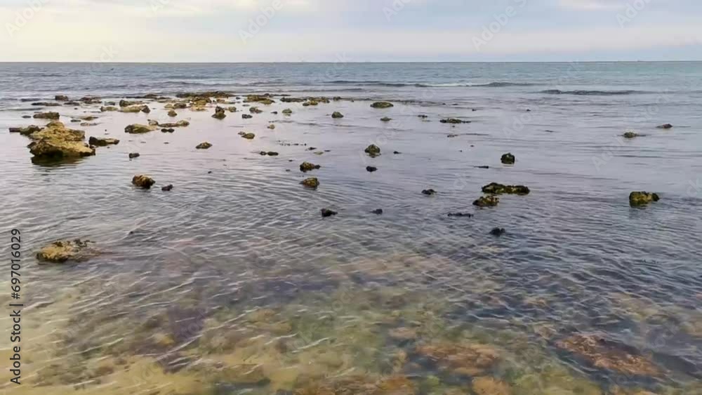 Stones rocks corals turquoise green blue water on beach Mexico.