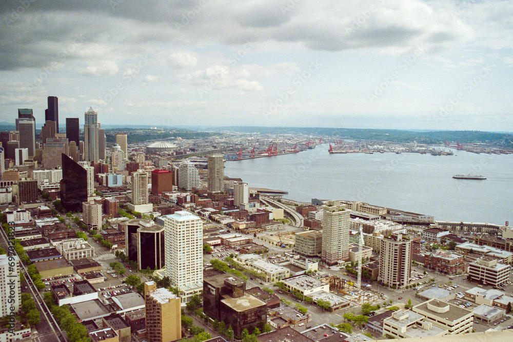 Grainy film photograph of downtown Seattle buildings and Puget Sound waterfront in Washington State.  Shot May 1992.  