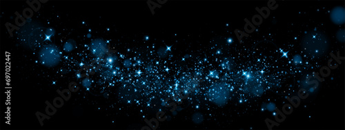 Bokeh, dust sparks and blue stars shine with special light. Vector sparks on black background. Christmas light effect. Sparkling magic dust particles. photo