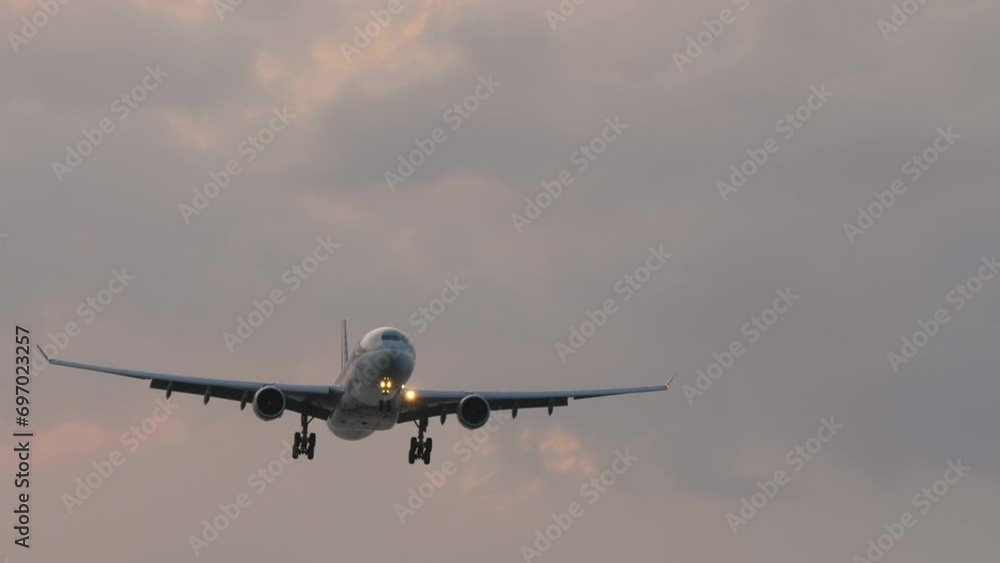 Widebody airliner approaching landing at sunset. Phuket International Airport. Flight arrival Widebody airliner approaching landing at sunset. Phuket International Airport. Flight arrival