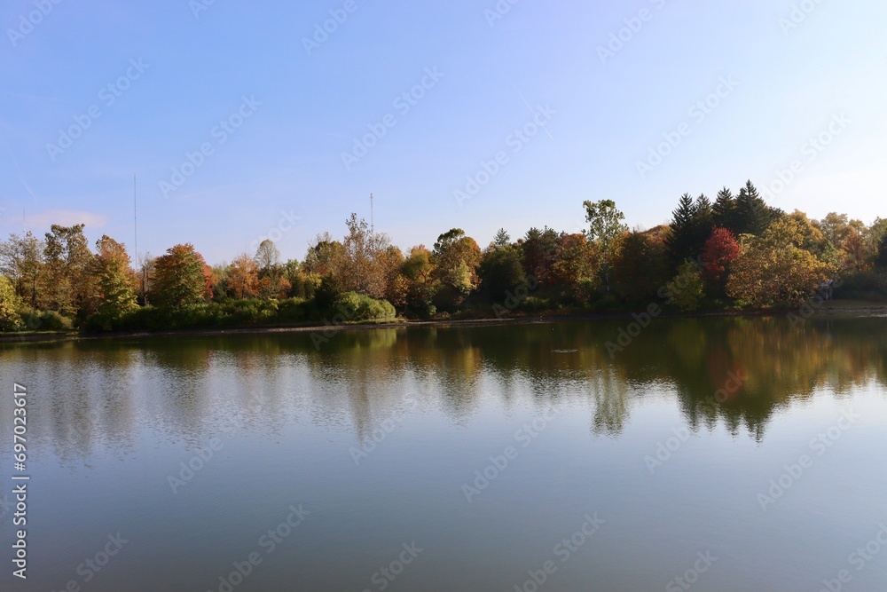 The calm lake in the countryside on a sunny autumn day.