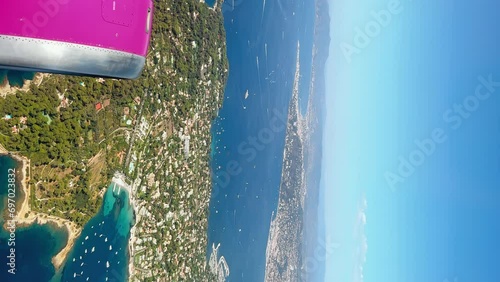 Stunning aerial vertical view of the island from the airplane window. Slow motion. Coastlines of Cannes, France photo