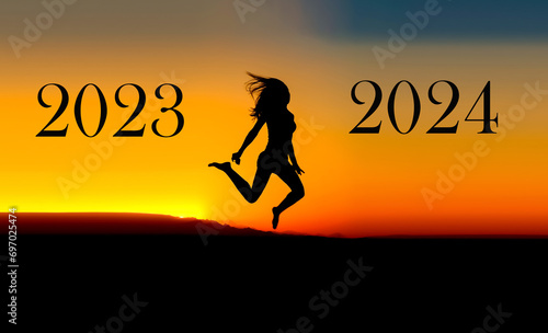 A woman jumps from 2023 to 2024 against the backdrop of sunset. New Year 2024