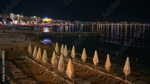 Beach of Majestic near the boulevard Croisette at night. People playing at the shore photo