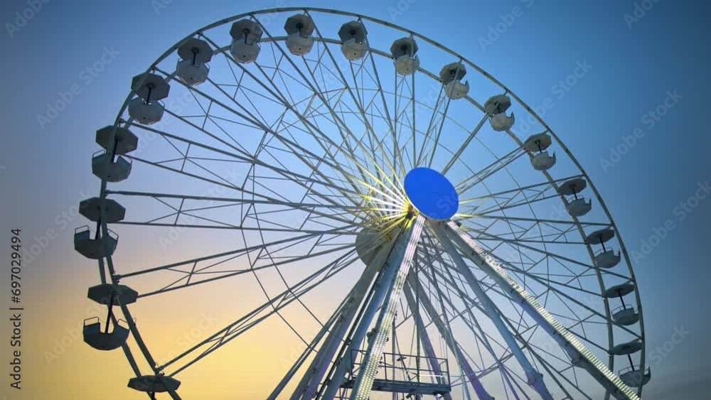 Giant ferris wheel at the Port Vauban at sunset in Antibes, France Giant ferris wheel at the Port Vauban at sunset in Antibes, France