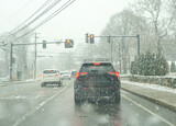 vehicle driving on urban street in snowing day