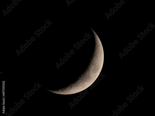 close up on waxing crescent moon on night sky