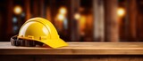 yellow construction hat sitting on wooden table