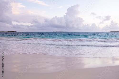 Fototapeta Naklejka Na Ścianę i Meble -  Calm Waters on the Shore of Orient Beach Before Sunrise, St. Martin