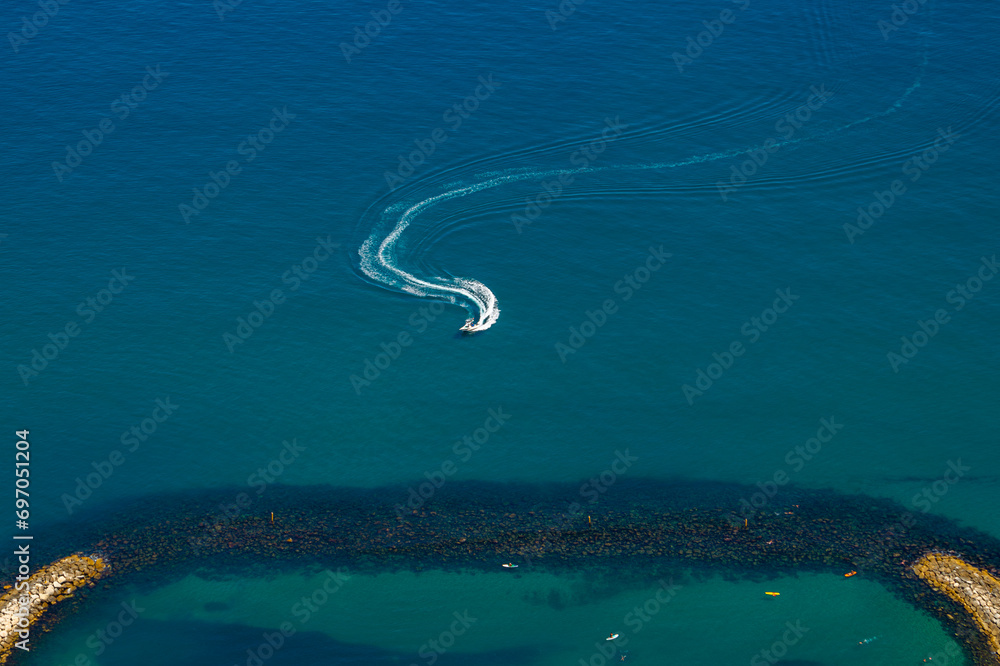 Boat sailing near the Sandy bay beach. View from the top of the Rock of Gibraltar Boat sailing near the Sandy bay beach. View from the top of the Rock of Gibraltar