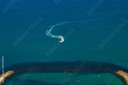 Boat sailing near the Sandy bay beach. View from the top of the Rock of Gibraltar