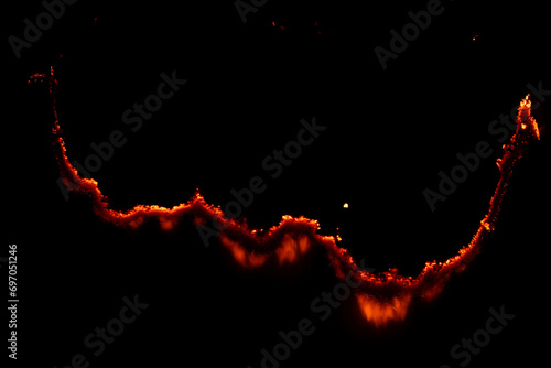 burning paper, glowing edge of paper on a black background photo