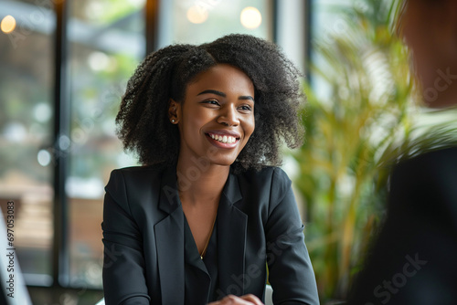 Meeting, recruitment or managers in job interview with young diverse african american businesswoman talking or listening in negotiation. Business people, smile or candidate speaking to happy hr manage