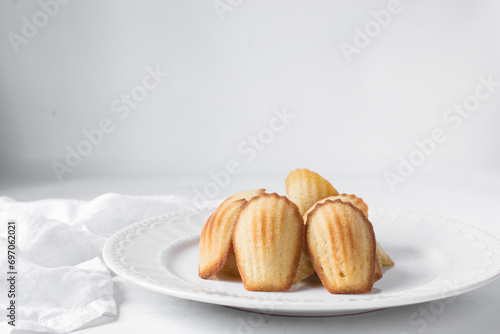vanilla madeleines on a white plate, plain french vanilla madeleine cake or cookie photo