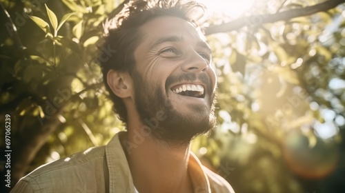 Portrait of young man laughing in the garden on a sunny day
