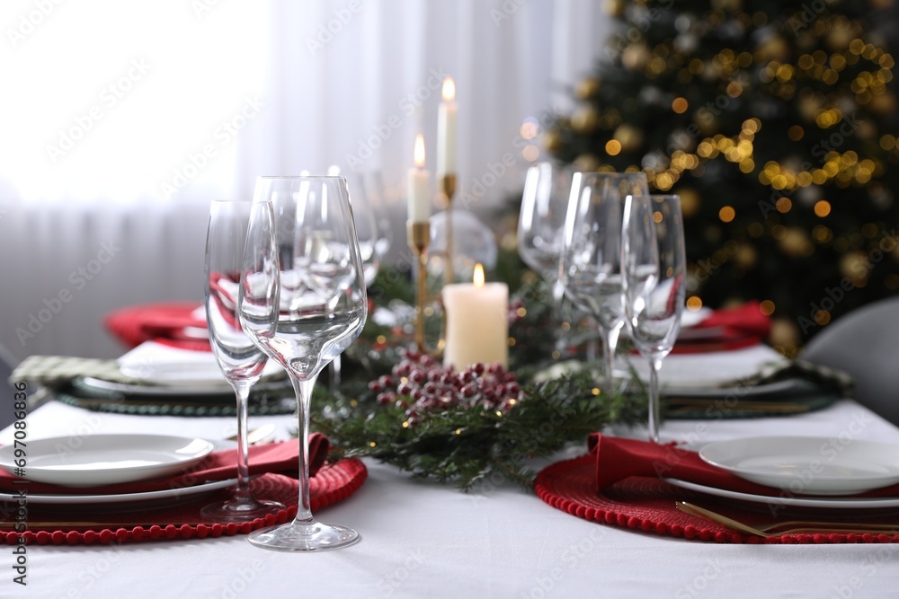 Fototapeta premium Christmas table setting with festive decor and dishware indoors