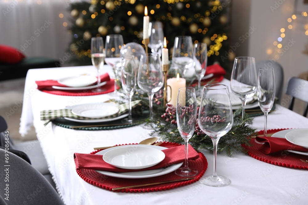 Christmas table setting with festive decor and dishware indoors Christmas table setting with festive decor and dishware indoors