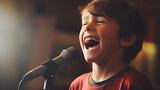 A young boy is singing into a microphone 