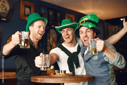 Men celebrate St. Patrick's Day at bar with a mug of beer