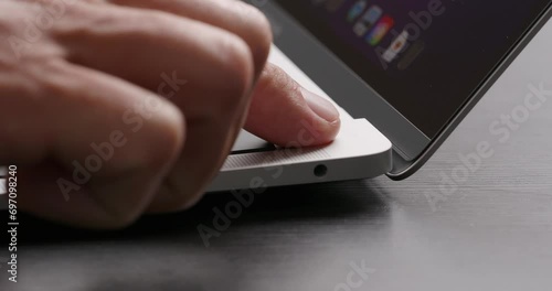 Close-up. Finger touch keyboard to unlock laptop without entering the password. 