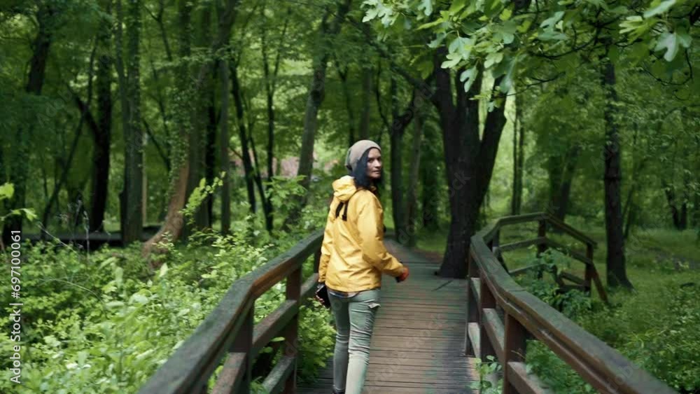Hiking woman walk in rainforest jungle. view of girl hiker walking through dense rain forest nature. Hiking woman walk in rainforest jungle. view of girl hiker walking through dense rain forest nature.