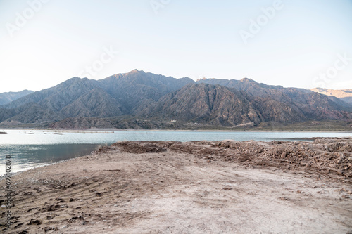 Natural landscape with mountains and lake outdoors on a sunny day.