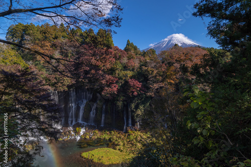 See Mount Fuji thru Shiraito Falls with rainbow in autumn, Shizuoka, Japan photo