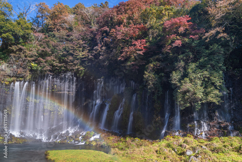 See Mount Fuji thru Shiraito Falls with rainbow in autumn, Shizuoka, Japan