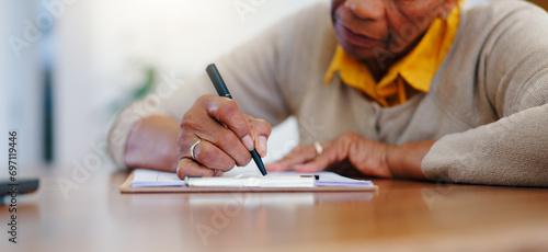 Senior woman, hands and writing agreement on contract, form or application for retirement plan or insurance at home. Closeup of elderly female person signing documents or paperwork on table at house photo