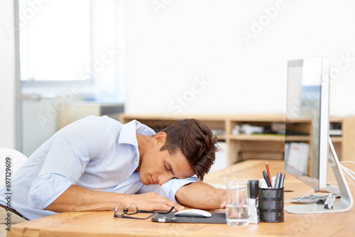 Businessman, sleeping and computer on desk at office in fatigue, burnout or mental health. Tired man or employee asleep or taking a nap in relax or rest sitting on chair or table by PC at workplace photo