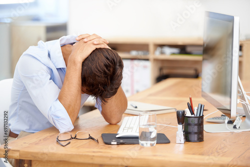 Frustrated businessman, headache and mistake in stress, burnout or fatigue by computer at the office. Man or employee with migraine in anxiety, mental health or work pressure by PC desk at workplace photo