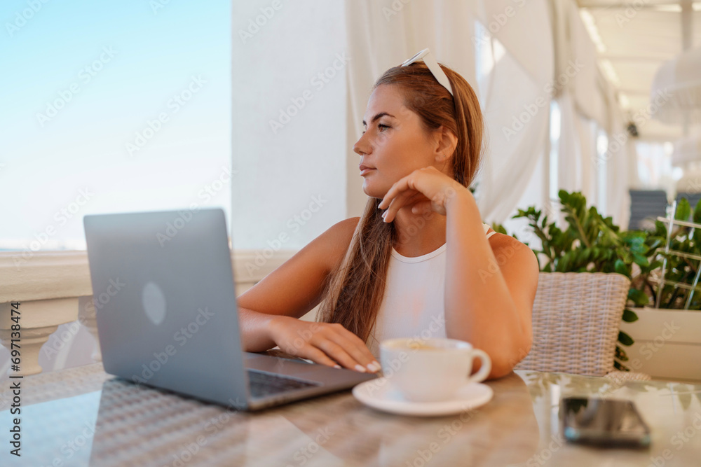 Woman coffee cafe laptop. Coffee break in cafe. Tranquil long haired woman drinking coffee in plant filled place. Woman sitting at a coffee shop with mobile phone drinking coffee. Woman coffee cafe laptop. Coffee break in cafe. Tranquil long haired woman drinking coffee in plant filled place. Woman sitting at a coffee shop with mobile phone drinking coffee.