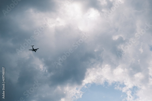 White passenger airplane flying in the sky clouds in the background