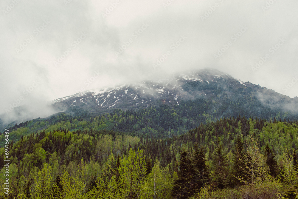 Dramatic fog rolls over a mountain range in Alaska.