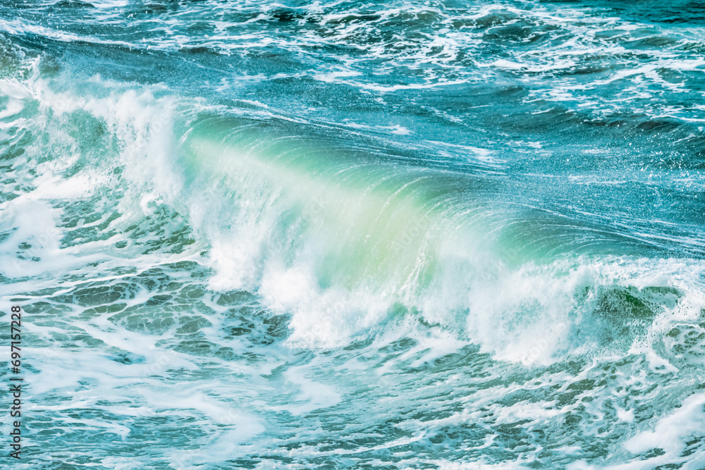 Fototapeta premium Wave splashing close-up. Crystal clear sea water, in the ocean in San Francisco Bay, blue water, pastel colors.