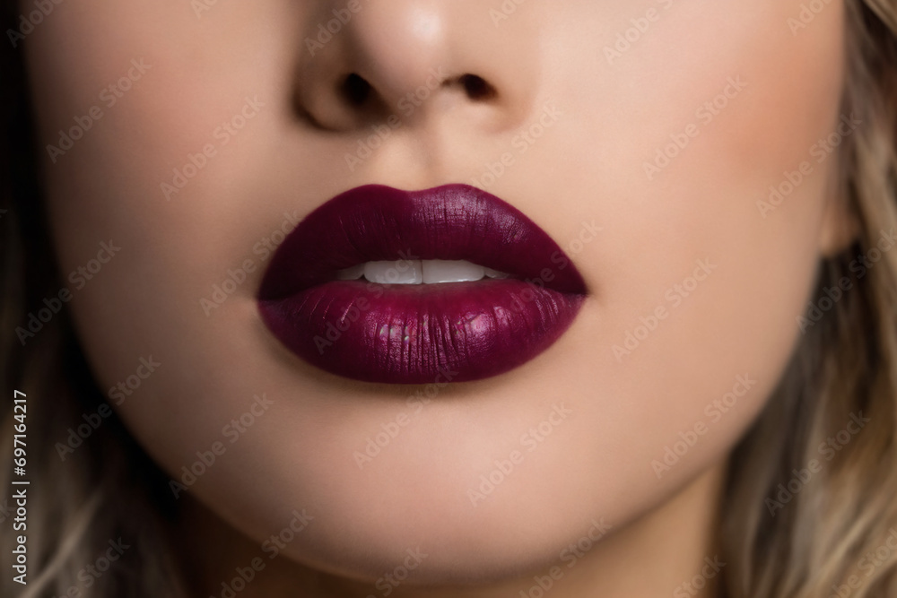 Fototapeta premium Close-up of beautiful lips with bordeaux lipstick