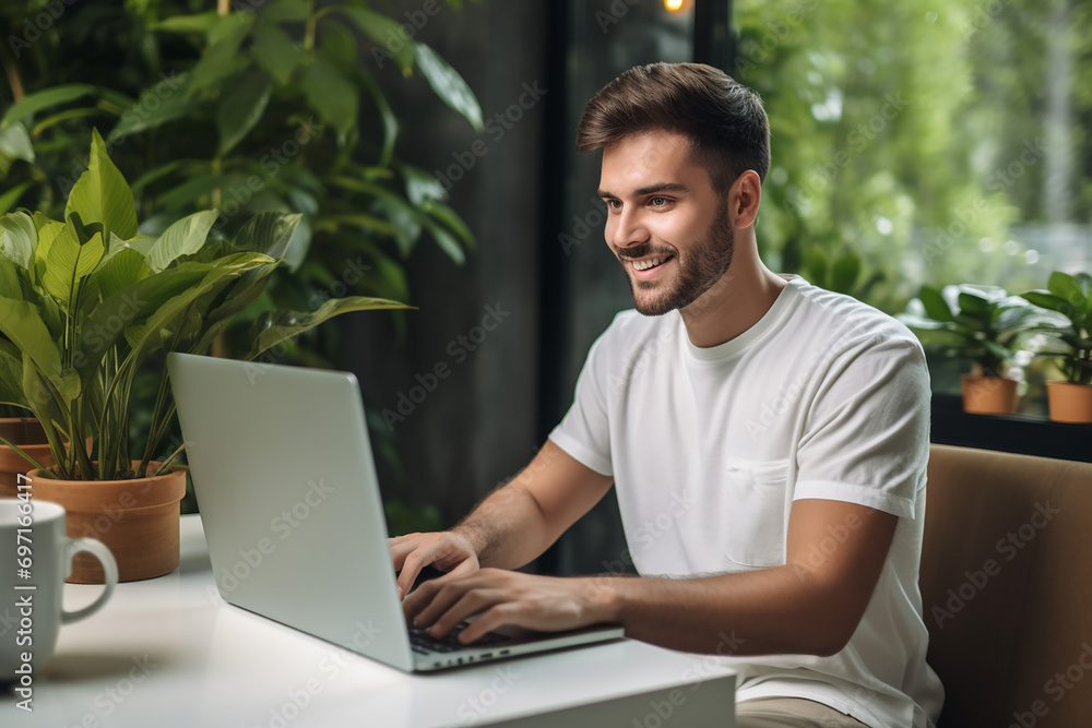 Male entrepreneur working on a computer at home Male entrepreneur working on a computer at home