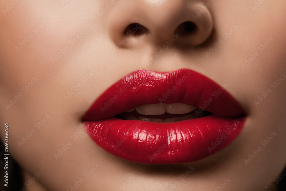 Fototapeta premium Close-up of beautiful lips with red lipstick