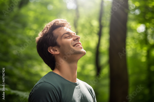 closeup portrait of sportsman in park with eyes closed breathing fresh