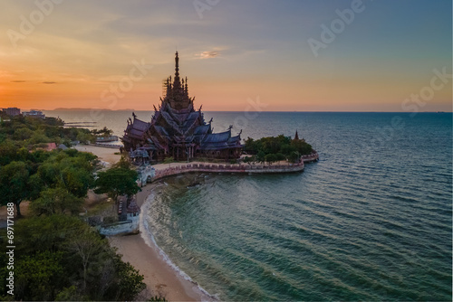 The Sanctuary of Truth wooden temple in Pattaya Thailand is a gigantic wooden construction located at the cape of Naklua Pattaya City Chonburi Thailand at sunset by the ocean